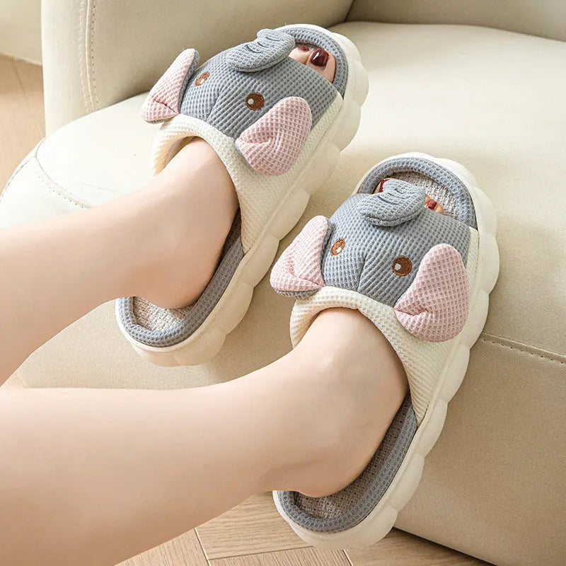 Elephant grey open-toe linen slippers for couples on a plain background.