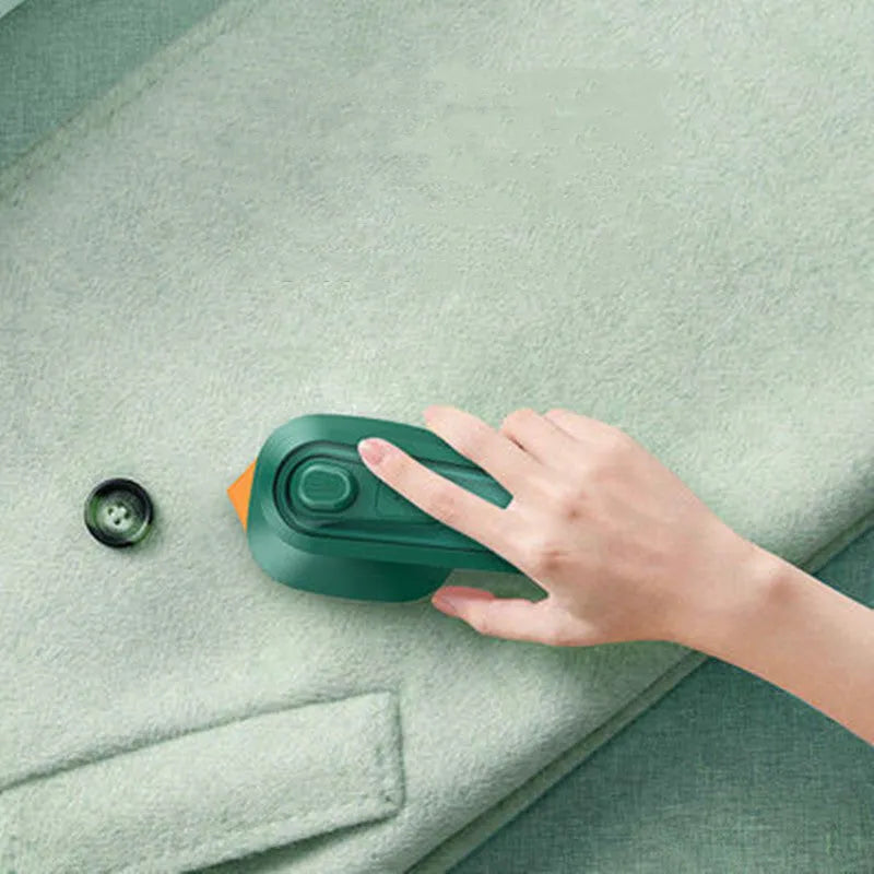 Dark green portable hanging steam iron with ceramic panel and compact design for travel use