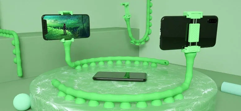 Black flexible arm phone holder with suction cup mounted on a desk, showing 360° rotation.
