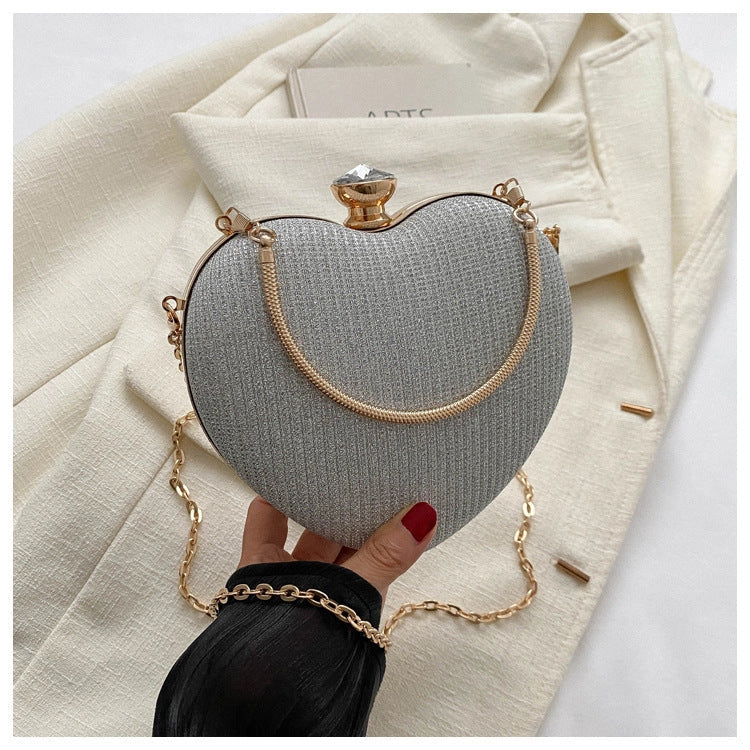 Heart-shaped shiny metal clutch bag with chain strap in various colours