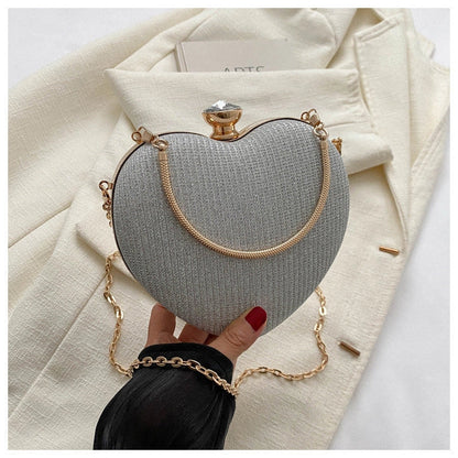 Heart-shaped shiny metal clutch bag with chain strap in various colours