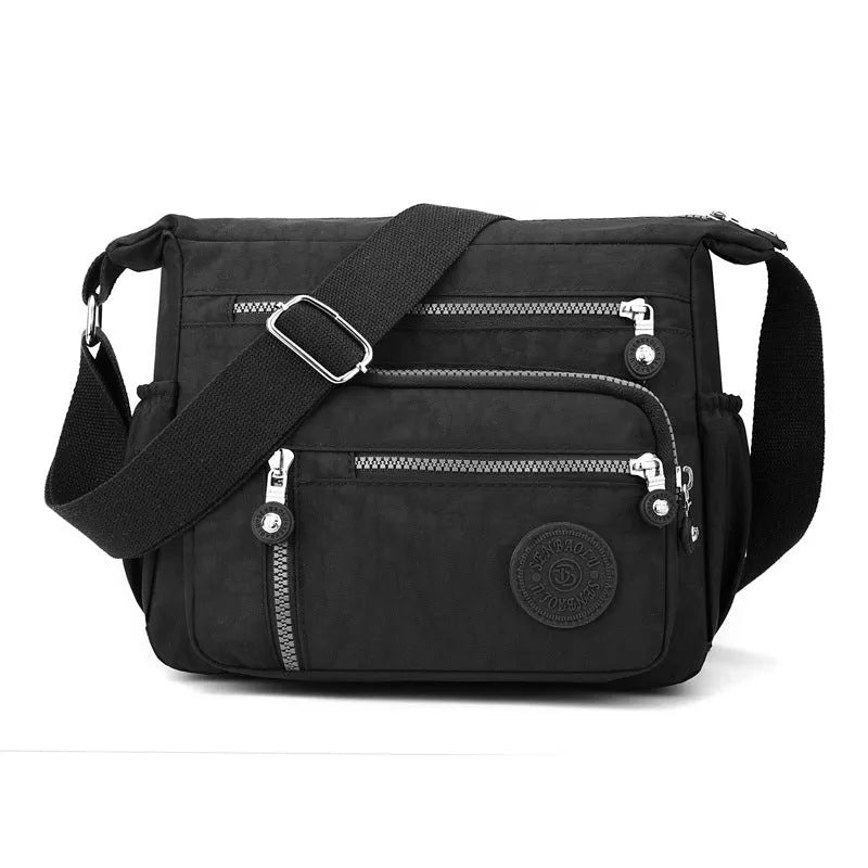 Lightweight grey nylon shoulder messenger bag with a single strap, shown in a square vertical shape.