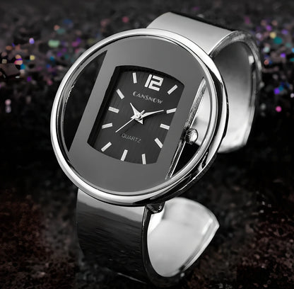 Women's gold black quartz cuff watch with 40mm dial, adjustable steel band 18mm wide, precise movement and water resistant