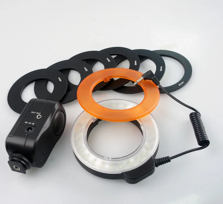 W48 LED ring light with 48 beads, six adapter rings, white and amber shades, on a table