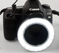 W48 LED ring light with 48 beads, six adapter rings, white and amber shades, on a table
