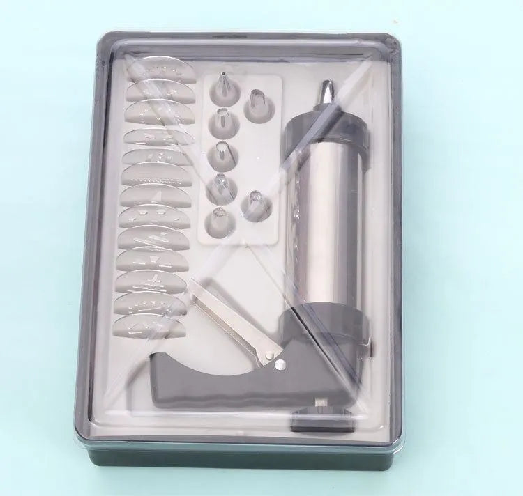 Stainless steel biscuit press gun with assorted cookie moulds and piping nozzles for baking.