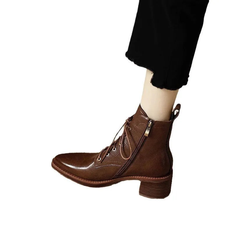 Women's black pointed-toe short tube boots with 5.5cm block heel on wooden floor