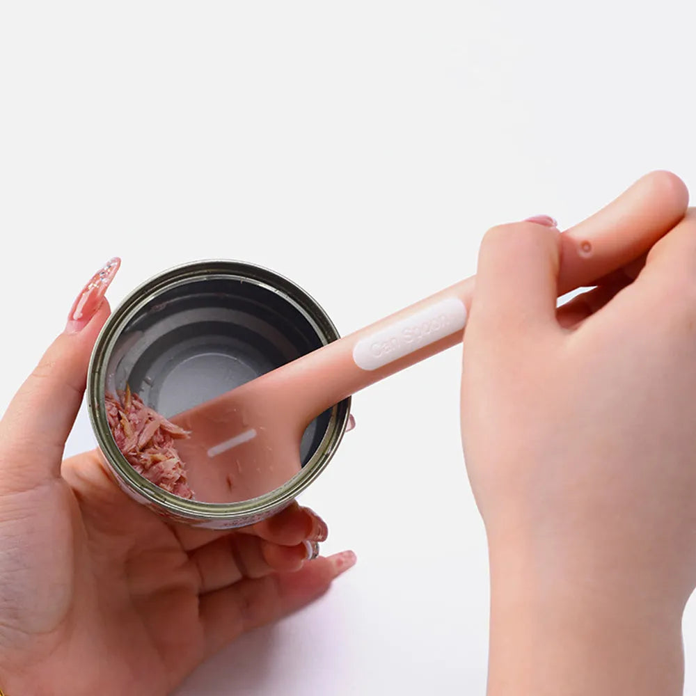 Green TPR pet feeding spoon with a long 16cm handle and right-angle scoop for canned wet food.