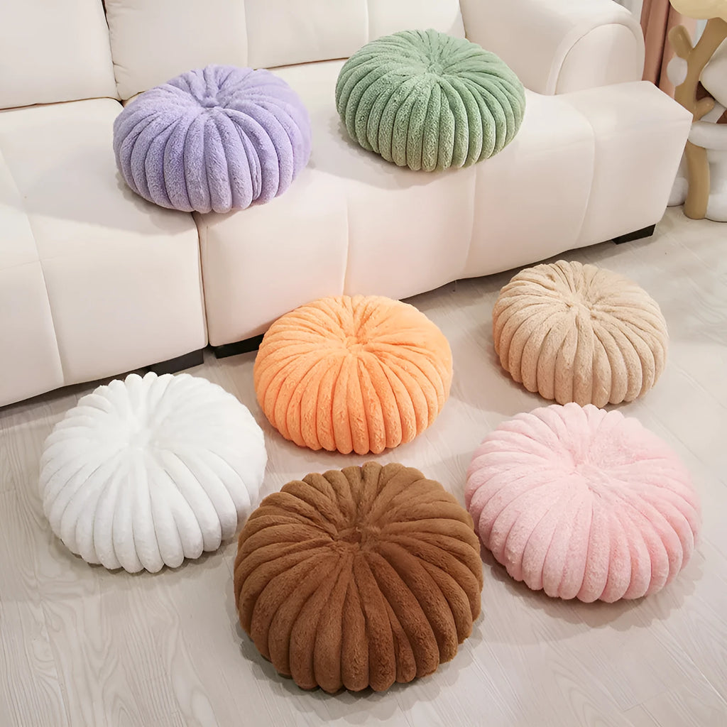 Pumpkin shaped seat cushion in khaki with short plush cover, 35x35x15cm, next to a window