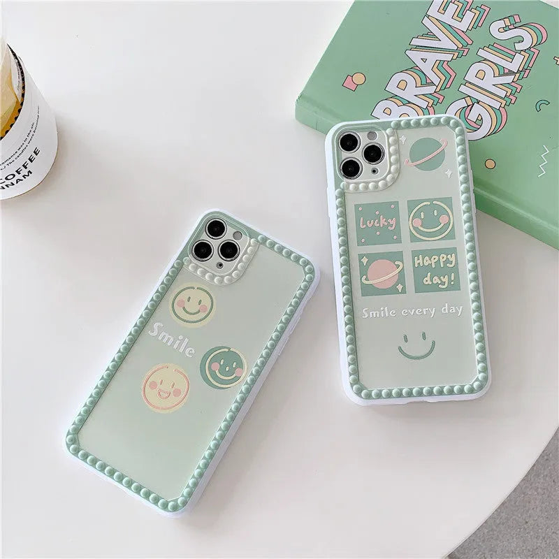 Green TPU iPhone back cover with geometric pattern featuring smiley faces and a polka dot frame.