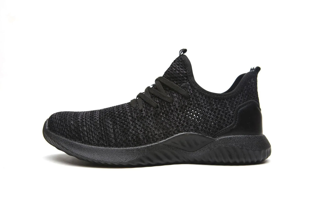 Black steel toe cap safety shoes with low-cut design on a work site background.
