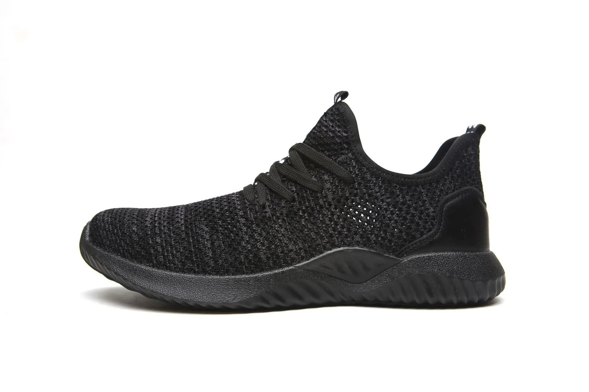 Black steel toe cap safety shoes with low-cut design on a work site background.