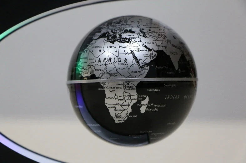 Magnetic levitation globe floating above base with LED light on