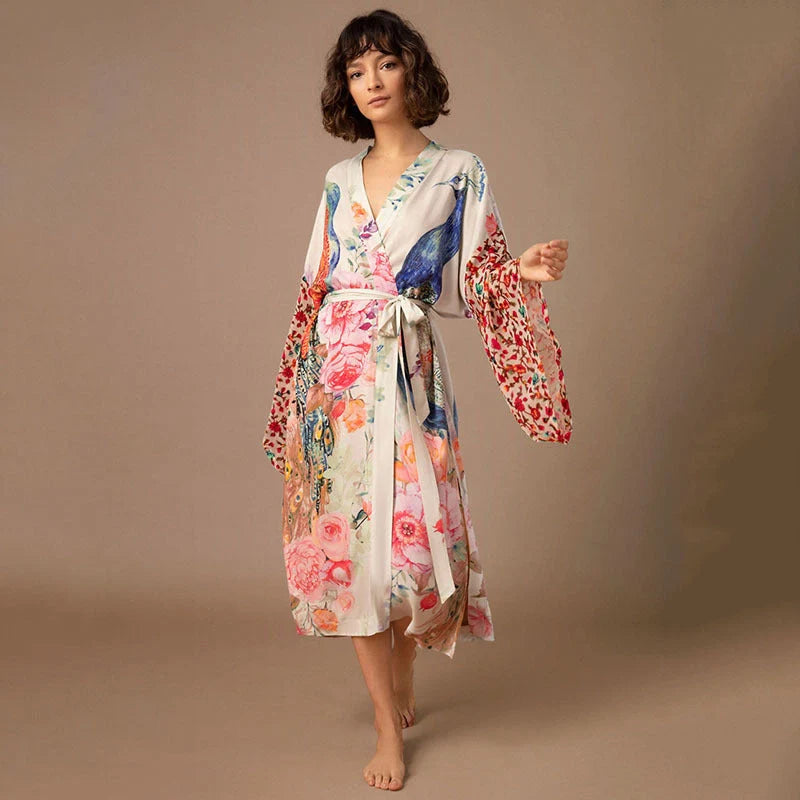 Peacock print beach cover-up in light pink and milky white, offering sun protection and style