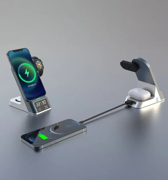 Black multifunctional wireless charging alarm clock with digital display and phone on charging pad.
