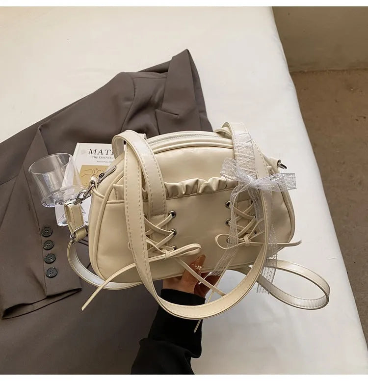 Women's casual PU bandage bow shoulder handbag with visible stitching, shown in milky white colour.