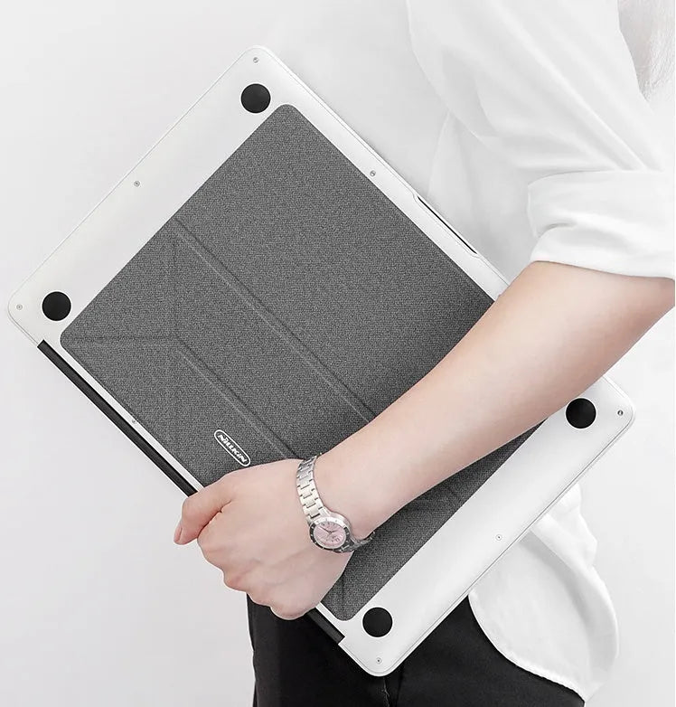 Blue foldable aluminium laptop cooling bracket open on a desk next to a laptop.