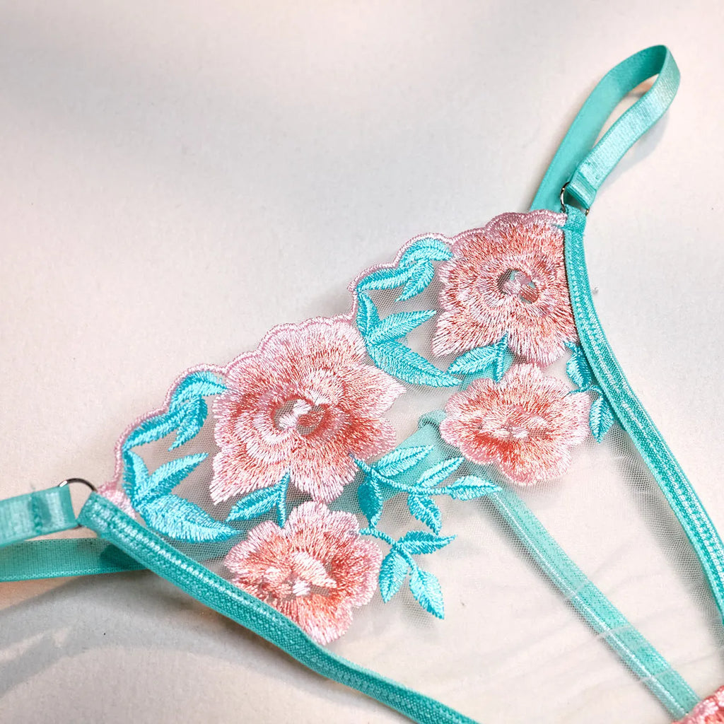 Pink women's bikini set with embroidery detail and a matching sheer mesh pettiskirt skirt.