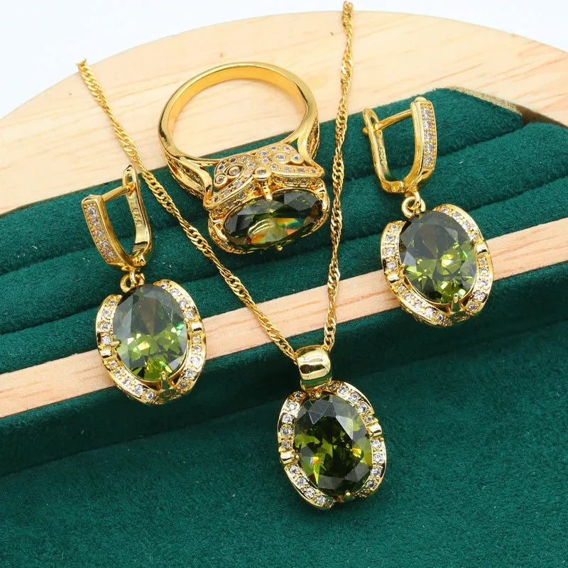Olive green zircon jewellery suit for women featuring a snake bones chain necklace, matching earrings, and ring with a crown pattern.