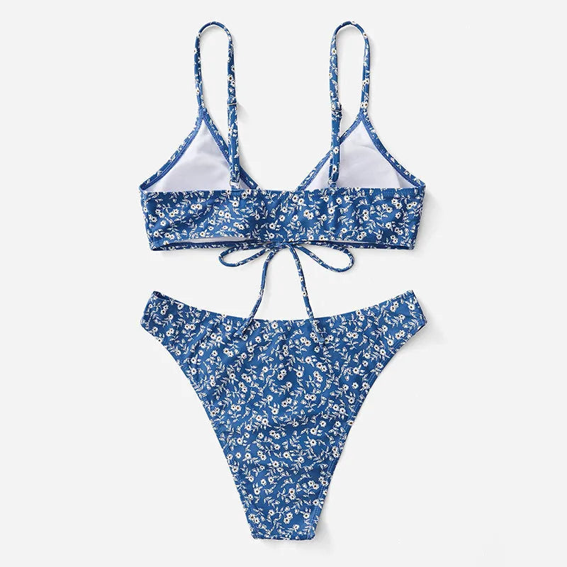 Blue women's swimsuit three-piece set showing separate top and shorts on a neutral background.