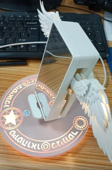 Angel Wings Wireless Charger with unfolding wings and aura base for fast 15W charging