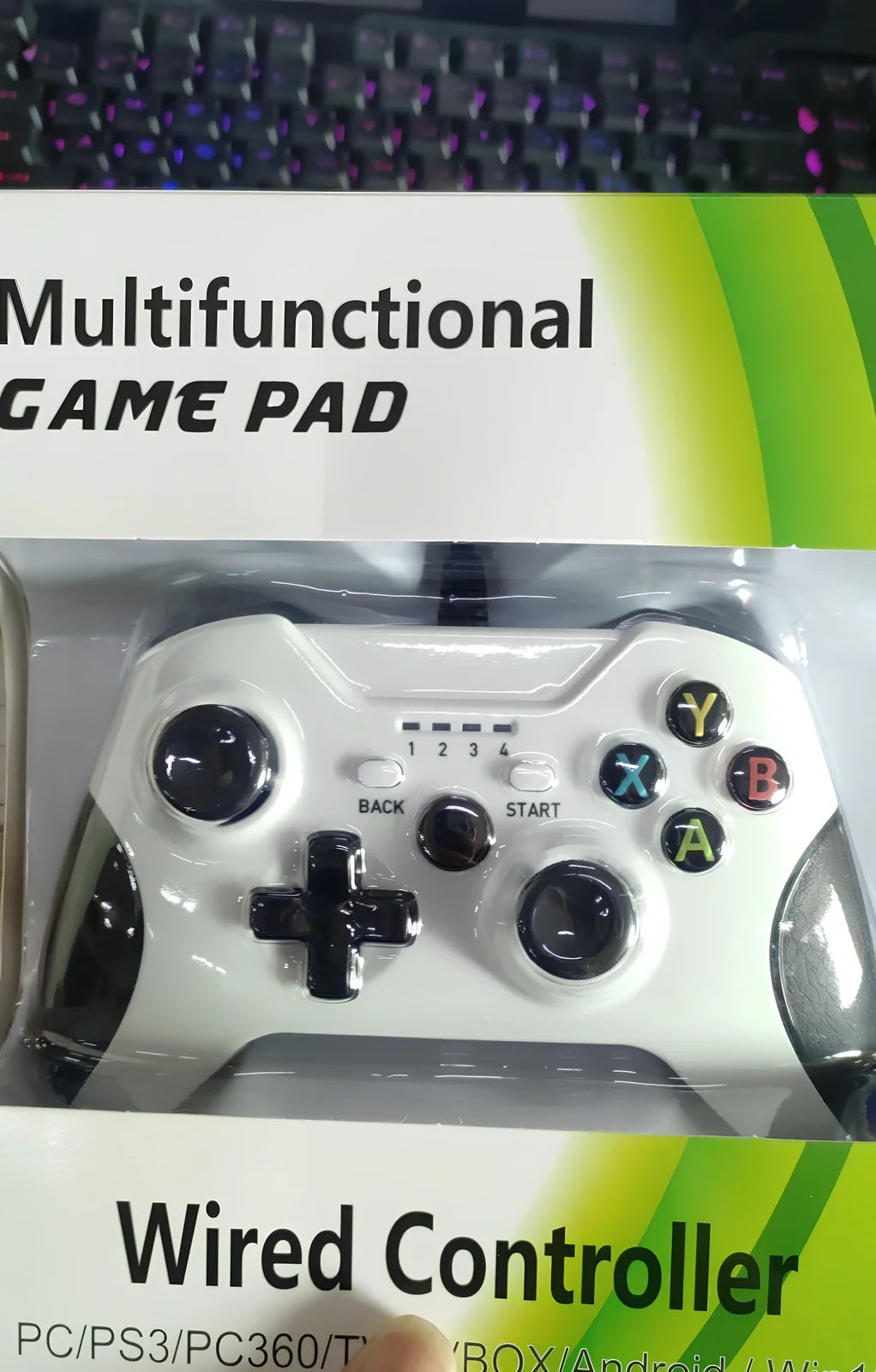 White Xbox One wired USB game controller with ergonomic grips and 2.5m cable on plain background