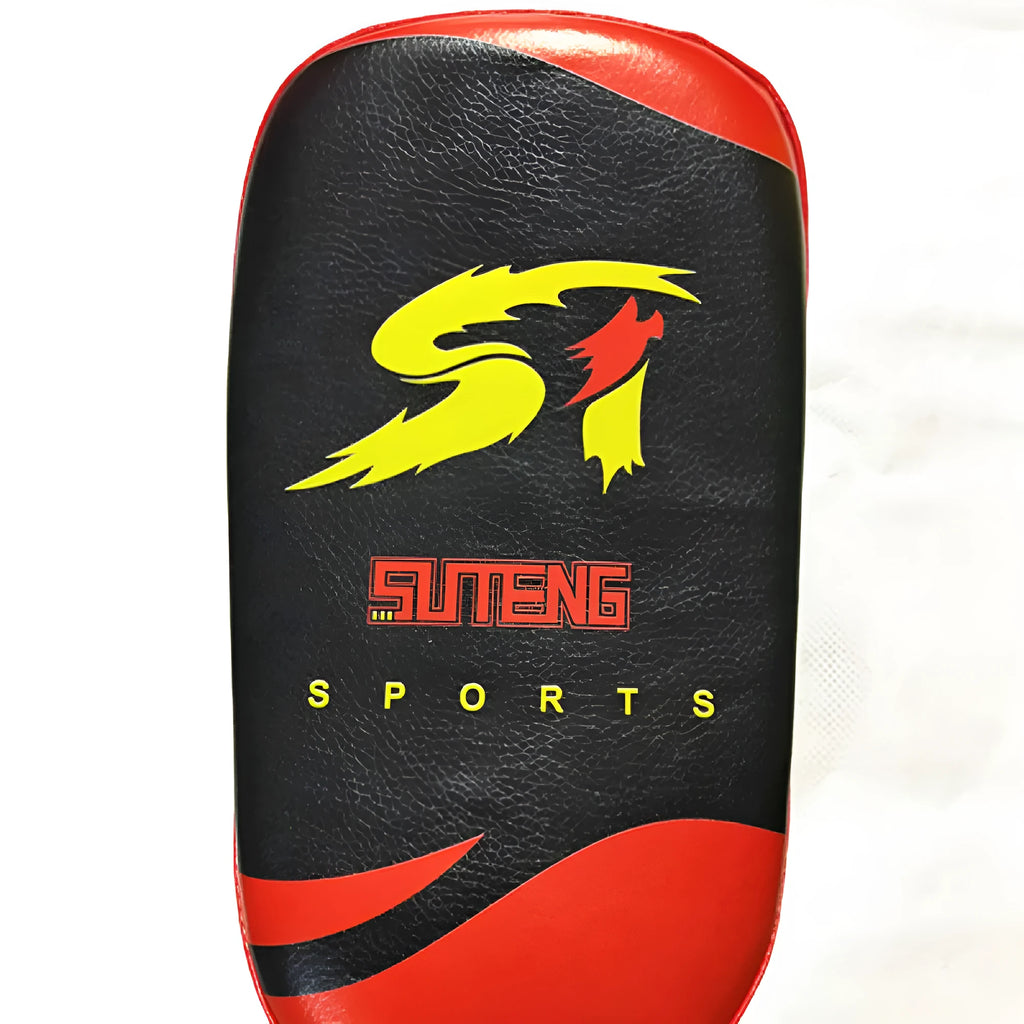 Black and red square martial arts training pad held in hand, showing double buckle strap.