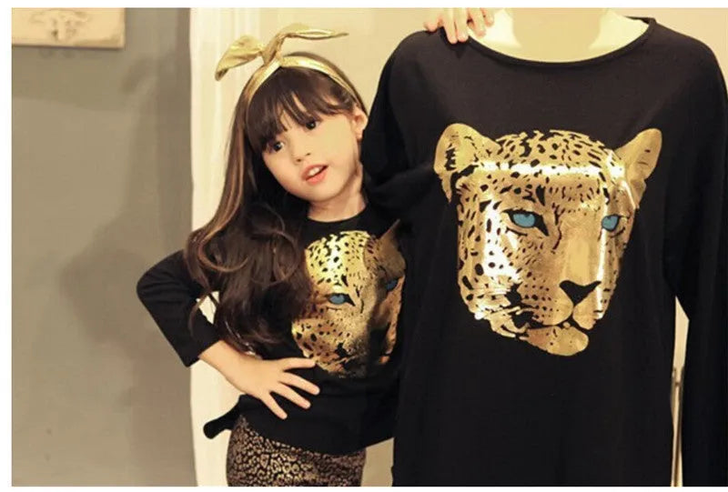 Two sets of children's casual summer pants suits in assorted colours on hangers.