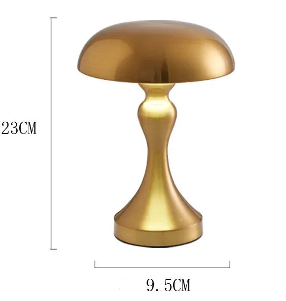 Metallic bronze LED desk lamp with touch control on a wooden desk next to a book.