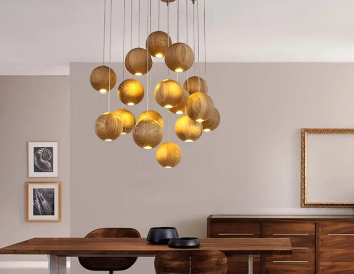 Nordic style solid wood ball chandelier hanging from a ceiling with an adjustable cord.