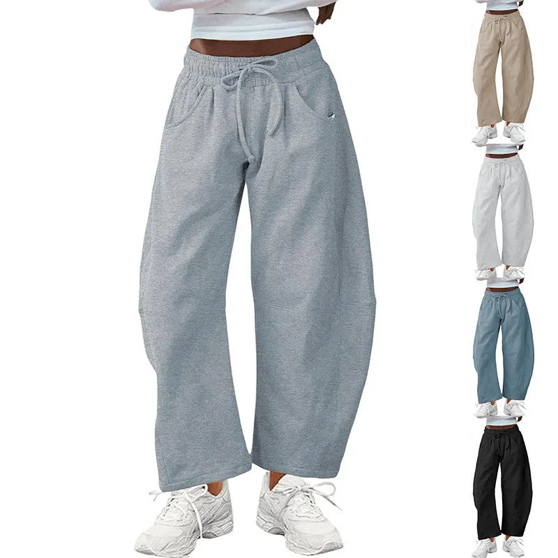 Loose cropped sports sweatpants with elastic waistband and drawstring pockets in street fashion style