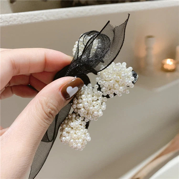 Korean pearl bow hair clip in black with alloy construction and manual bowknot design