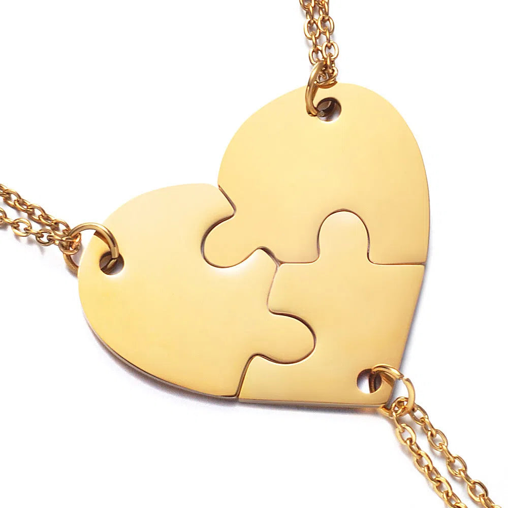 Stainless steel heart-shaped combination pendant necklace in gold finish on white background