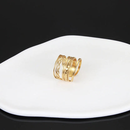 Adjustable stainless steel finger ring with unique charm designs in steel and gold colours