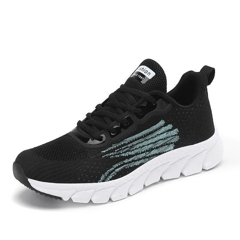 Women's low-top flat sneakers with cross-strap design in black and white colours
