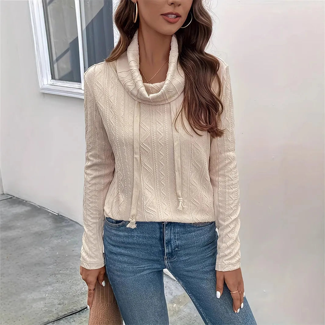 Apricot hooded pullover sweater with drawstring and long sleeves on hanger