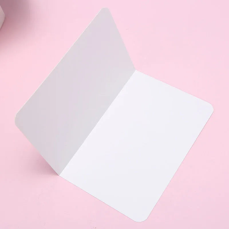 A pack of 100 folded kraft paper greeting cards in 10x15cm size, showing colour options: black, cowhide brown, and white.