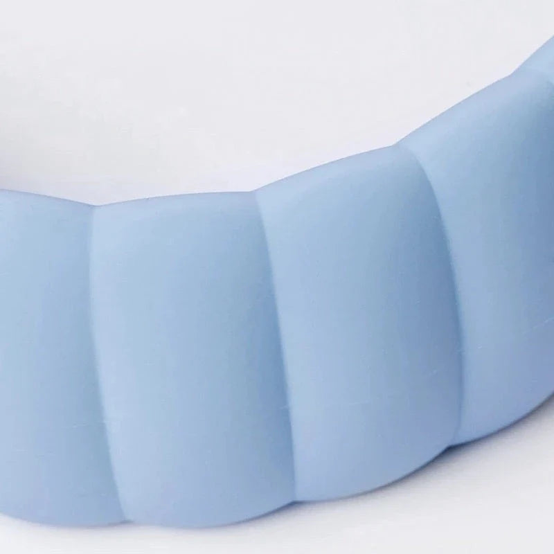 Cozy silicone hot water bottle with knitted cover, providing warmth and relaxation for neck, shoulders, and head