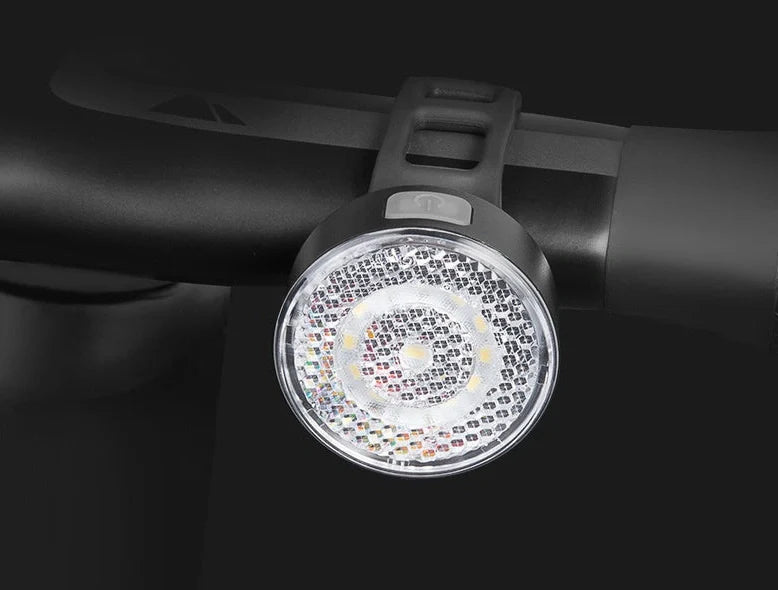 Bicycle LED headlight with clip attachment showing lens reflectors and USB port for charging