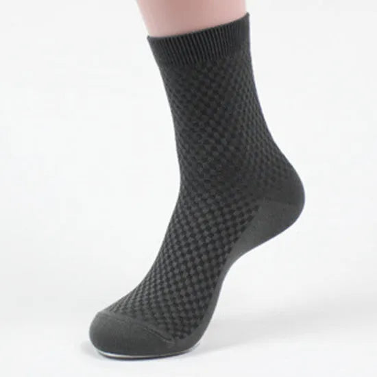 A pair of men's bamboo fibre ankle socks with a small square pattern, shown in one of the five available colours.