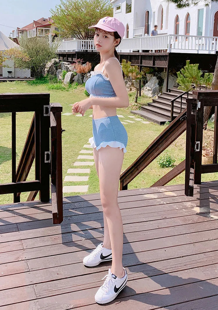 Women's conservative one-piece swimsuit with suspenders in a solid colour.