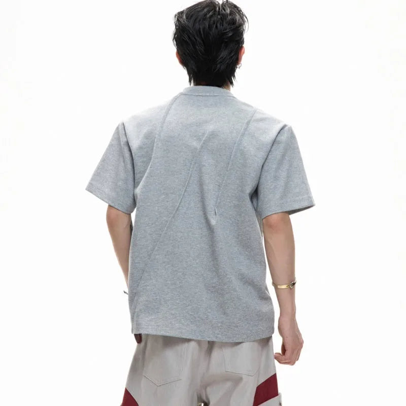 Men's grey loose fit cotton t-shirt with three-dimensional pleated texture detail on front.