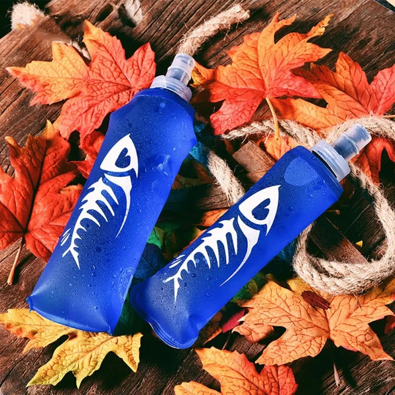 Blue sports soft water bottle with silicone lid on outdoor ground