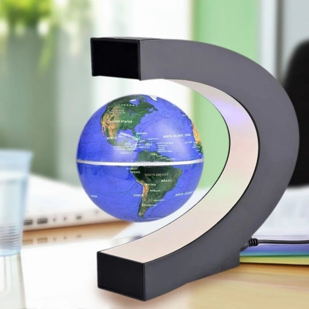 Magnetic levitation globe floating above base with LED light on