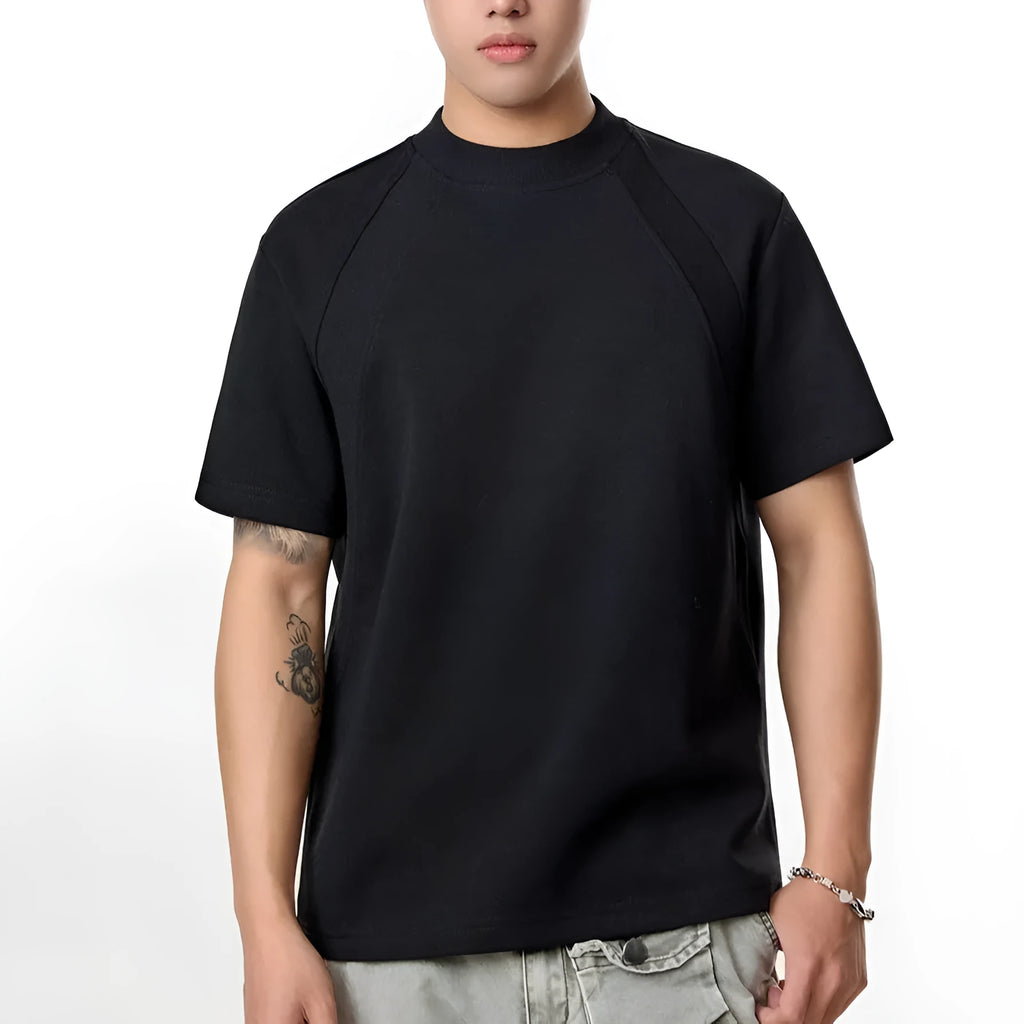 Man wearing a loose grey short sleeve top with visible air layer texture stitching on the front.