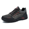 Men's brown suede hiking shoes with rubber sole and lace-up closure, showing round toe and mid-top design