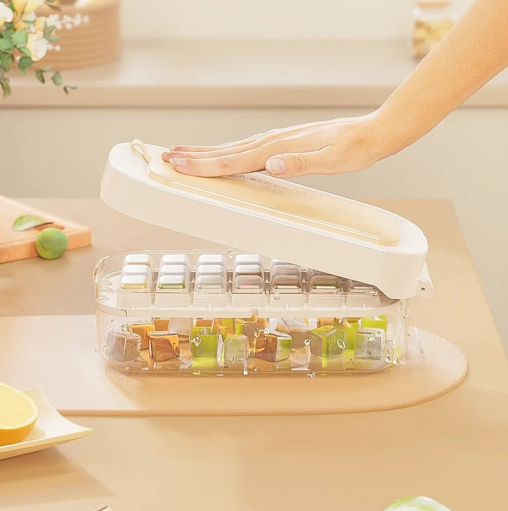Colourful high-capacity ice cube tray with grid design and an ice shovel stored in its slot.