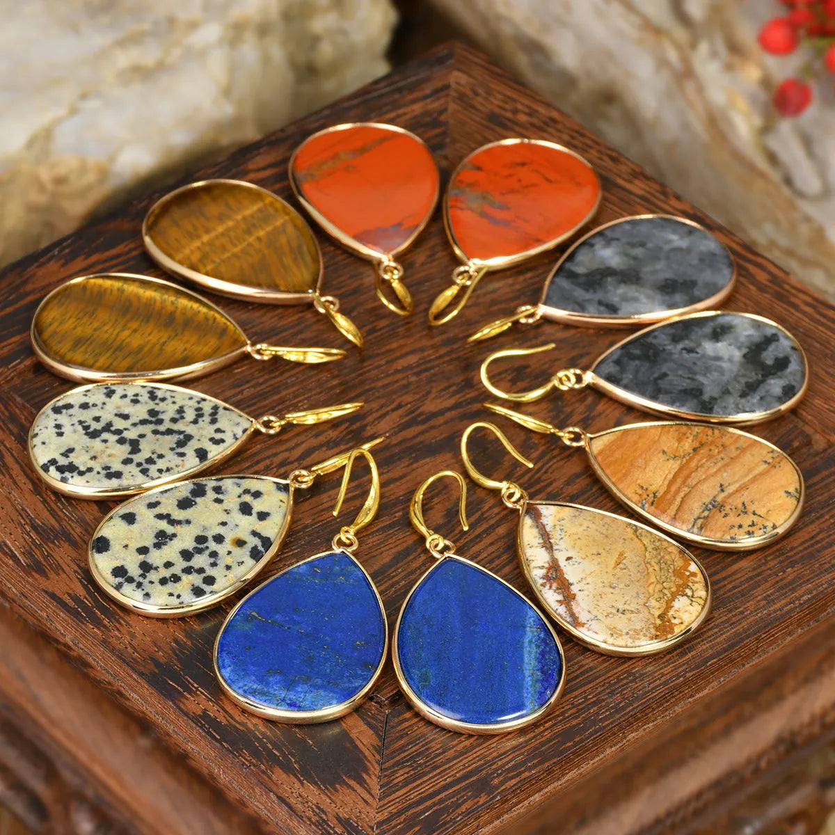 Close-up of women's retro water drop pendant earrings made from natural stone in a selection of colours.