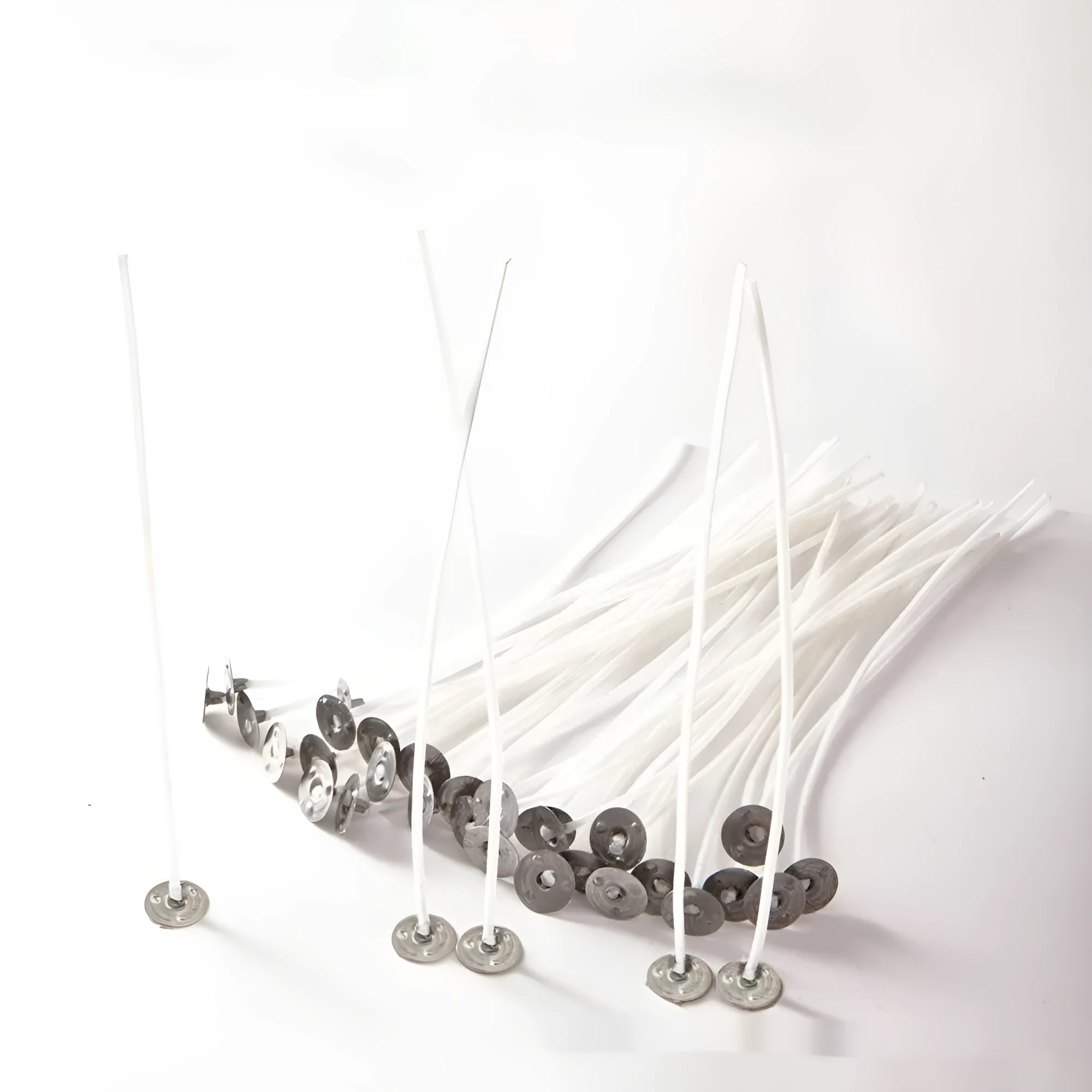 A bundle of white, tightly woven cotton candle wicks in varying lengths for DIY candle making.