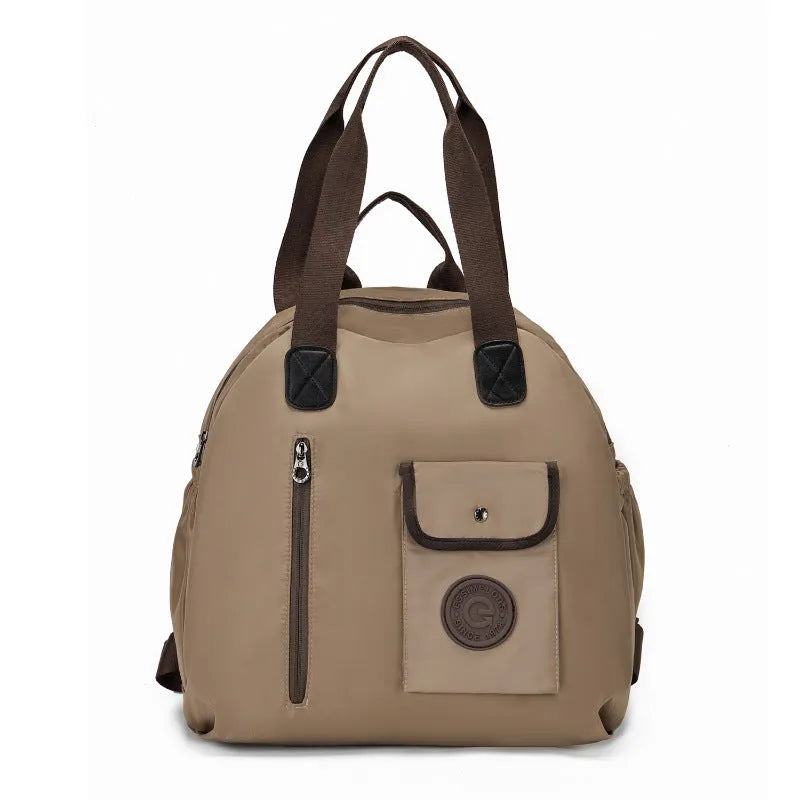 Large lightweight nylon backpack in khaki colour showing front sandwich pockets.